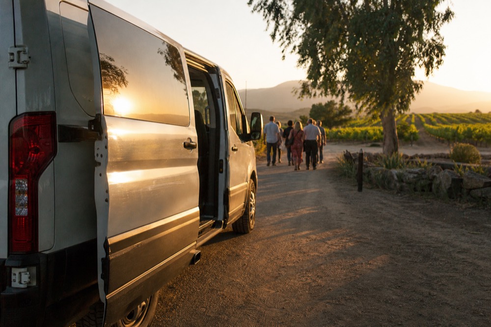 A tour van parked on a rural road beside a Willamette Valley winery
